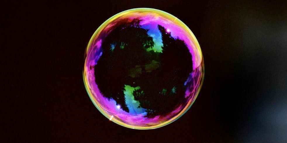 A colorful bubble on a dark background to illustrate the NFT bubble - Matters Lab